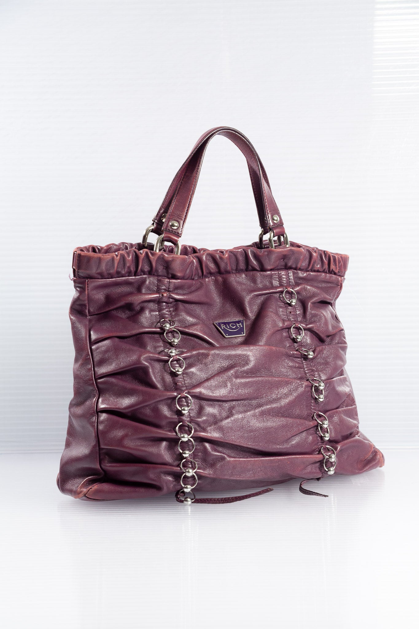 PURPLE PIERCED RUCHED LEATHER BAG