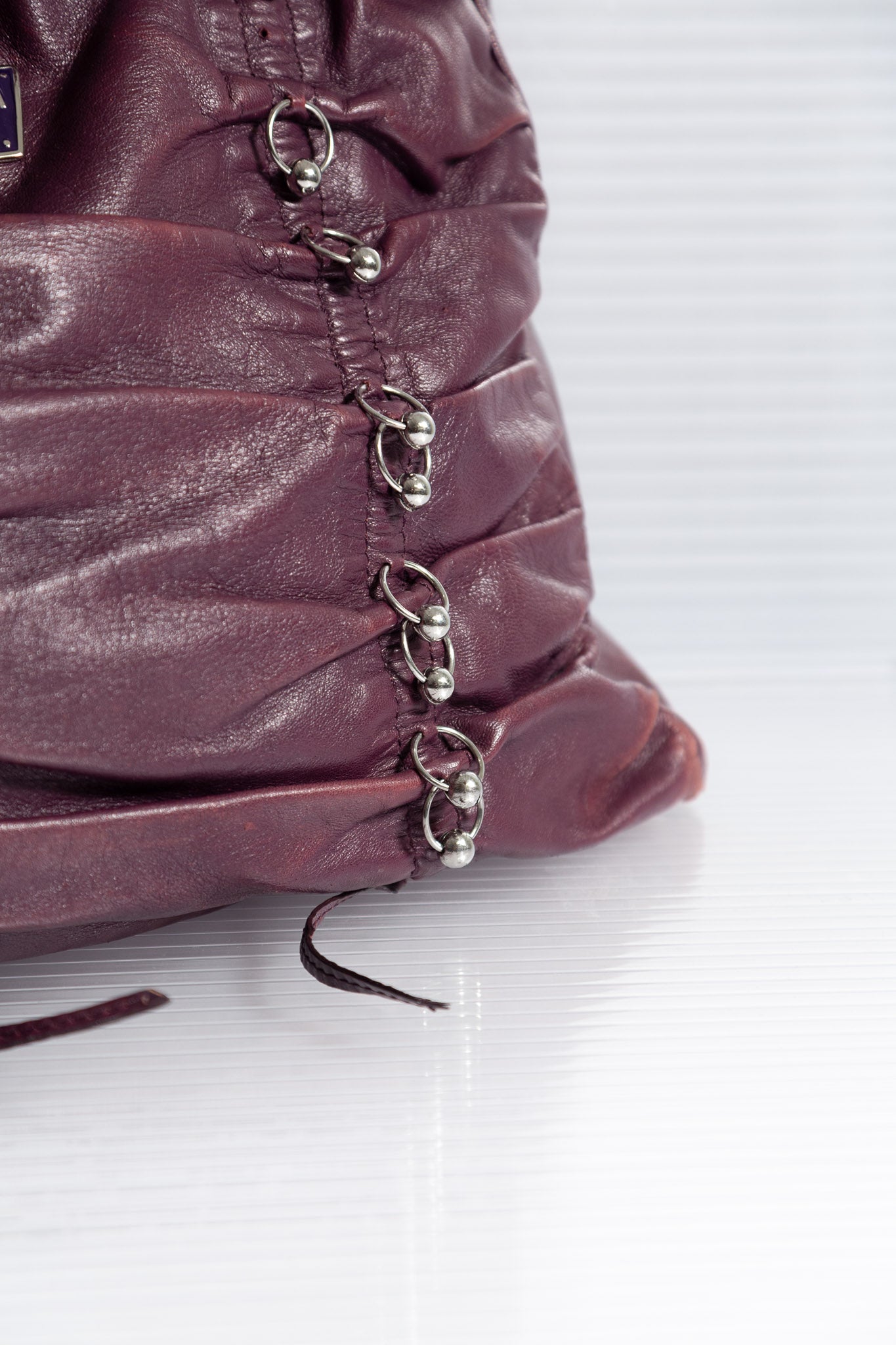 PURPLE PIERCED RUCHED LEATHER BAG