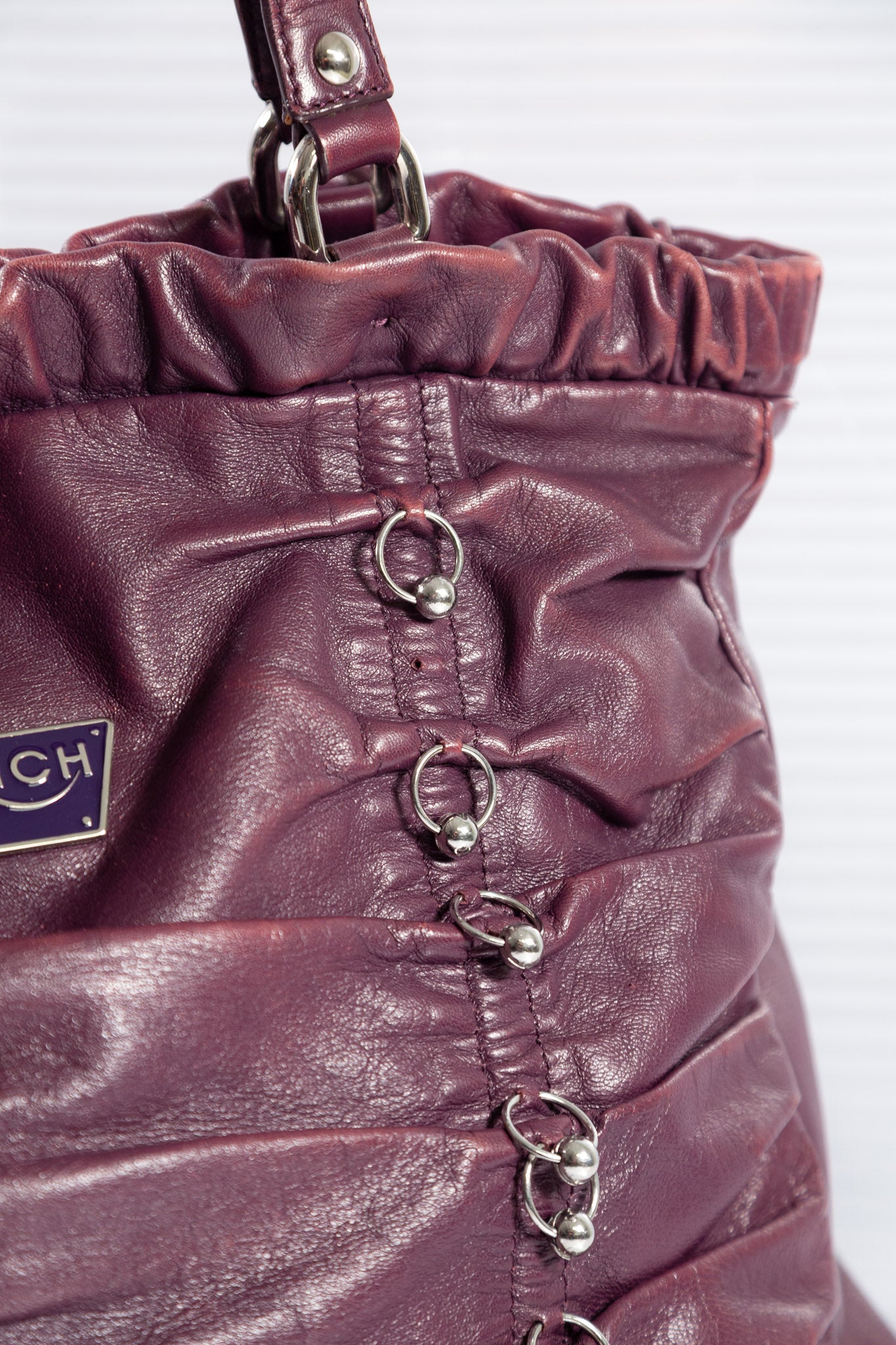 PURPLE PIERCED RUCHED LEATHER BAG