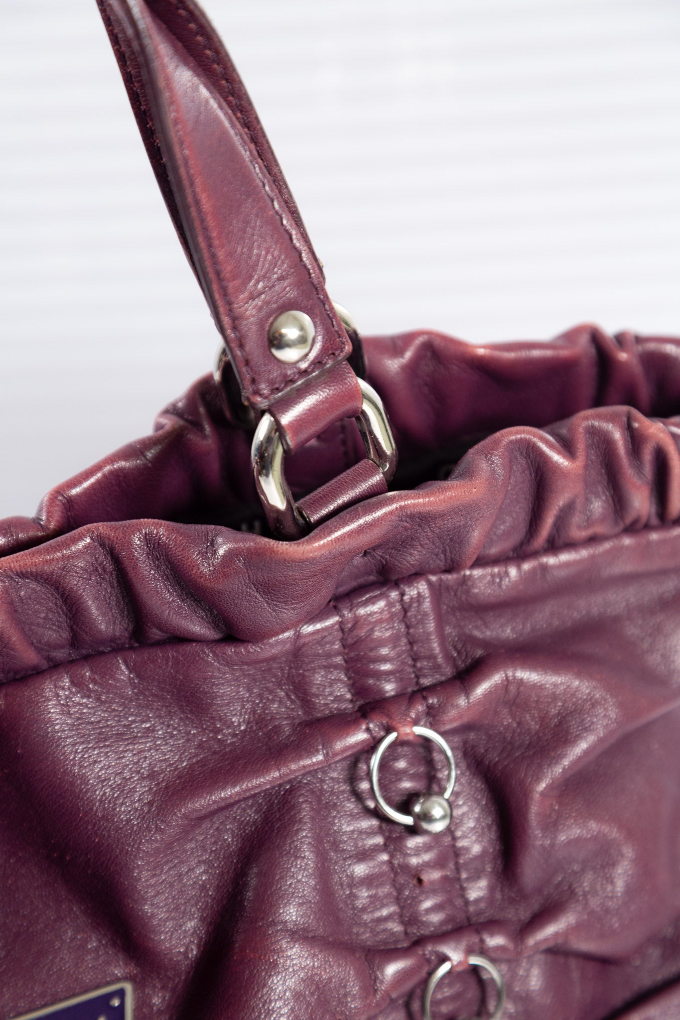 PURPLE PIERCED RUCHED LEATHER BAG