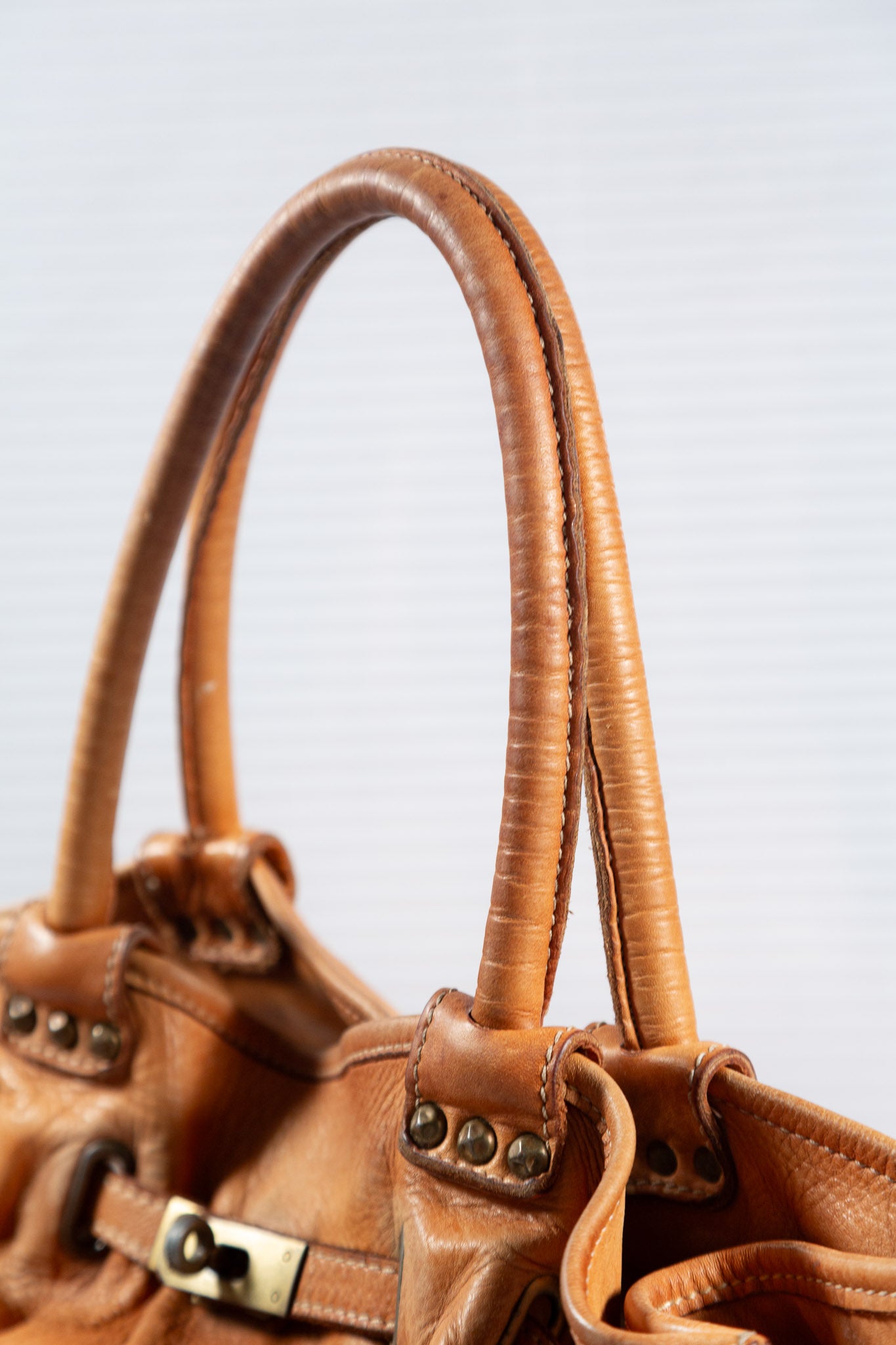 WASHED BROWN STUDDED FIRKIN LEATHER HANDBAG