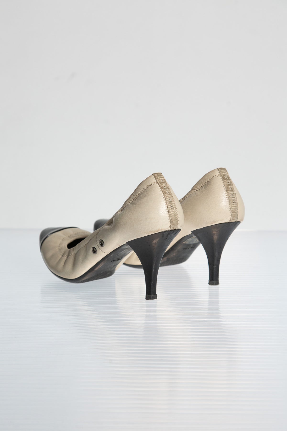 PRADA CREAM LEATHER PUMPS WITH BLACK TOE CAP