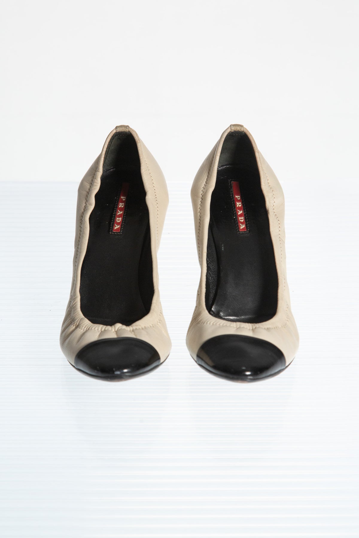 PRADA CREAM LEATHER PUMPS WITH BLACK TOE CAP