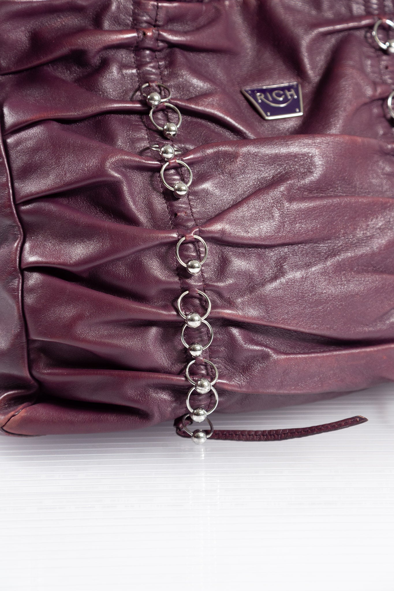 PURPLE PIERCED RUCHED LEATHER BAG